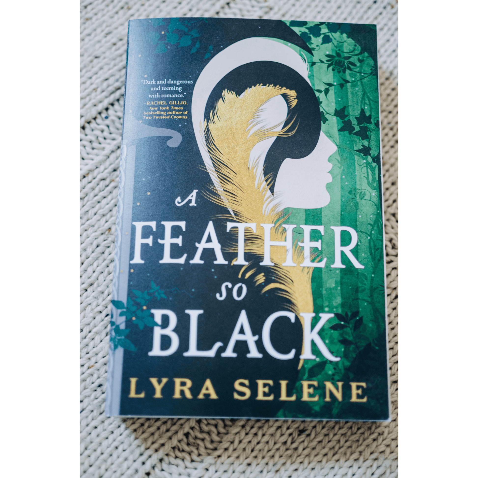 A Feather So Black by Lyra Selene, a fantasy romance book with an enchanting cover design.