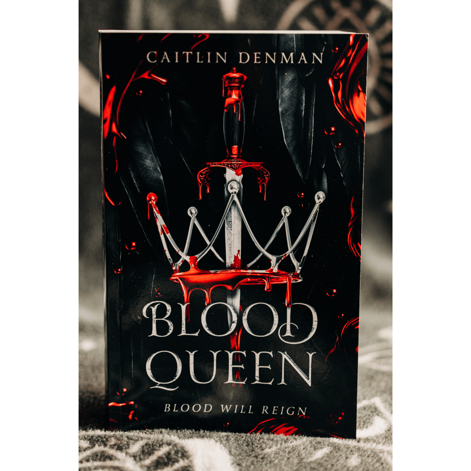 Cover of 'Blood Queen' by Caitlin Denman, featuring a crown and a bloodied dagger, perfect for fantasy romance fans.