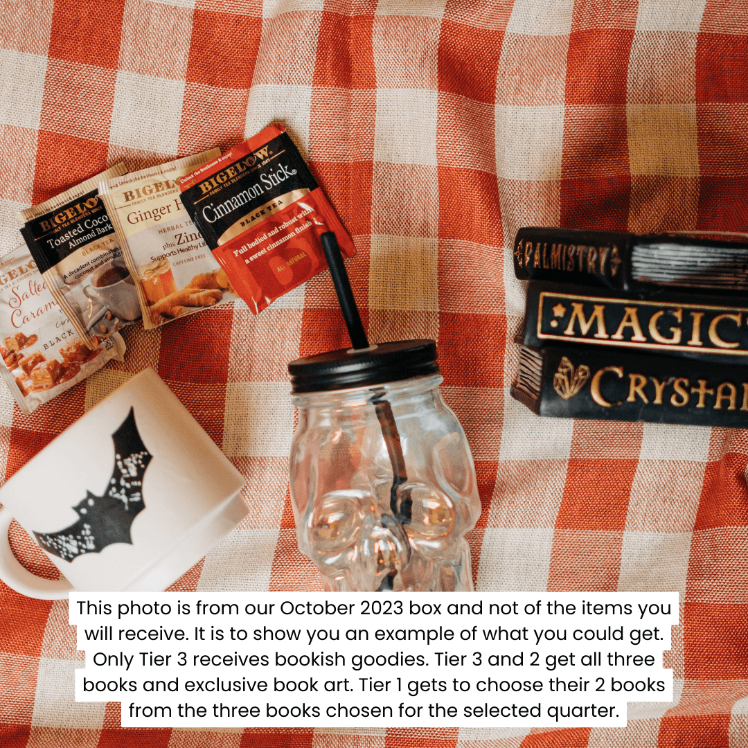 white mug with black bat on it, different fall flavored teas, a clear glass skull cup with lid and straw, and a magical book stack candle